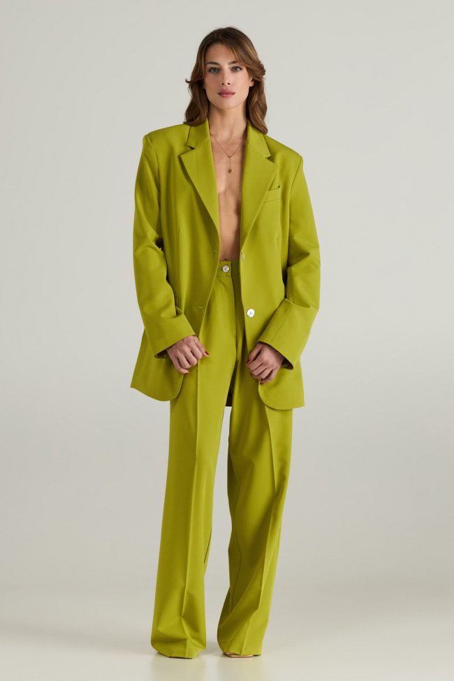 Model wearing light green cortsese set with blazer and high-waisted wide-leg pants.