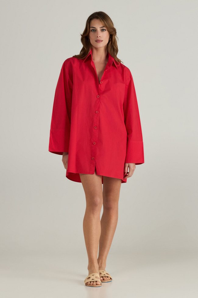 Model wearing a red travel dress,styled with minimal accessories and sandals
