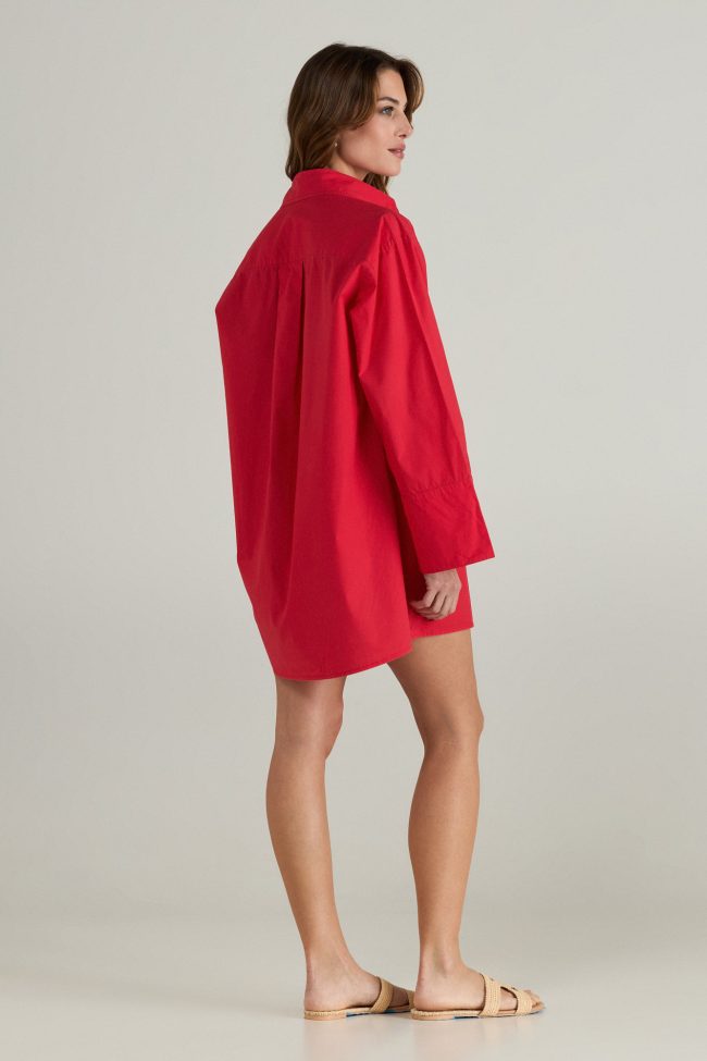 Model wearing a red travel dress,styled with minimal accessories and sandals