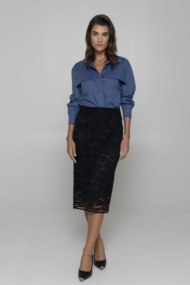 Model wearing black lace midi skirt with silk lining and blue shirt