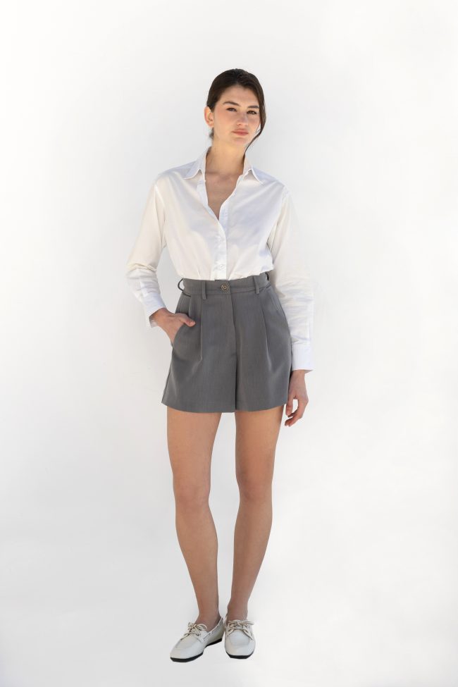 model wearing epure grey tailored shorts with white shirt flicka athens front view
